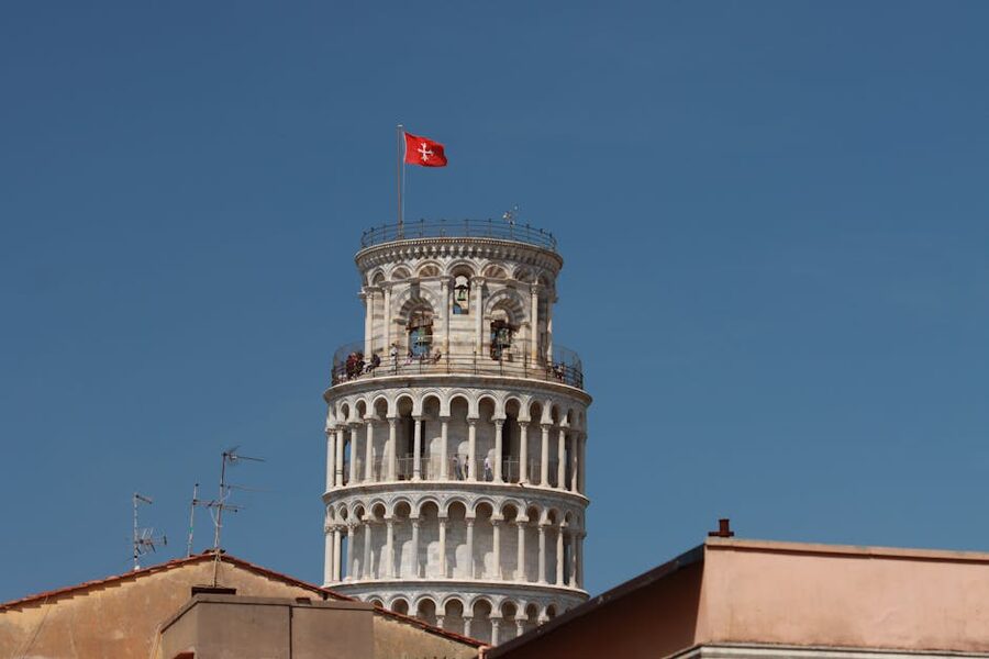 Leaning Tower of Pisa rising above Pisa rooftops