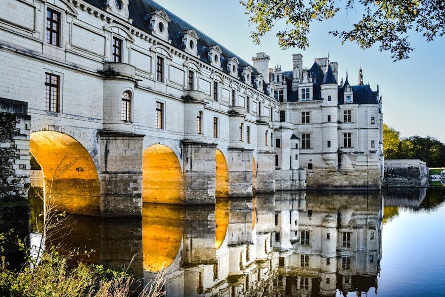 Chenonceau at dusk illuminated arches over the Cher
