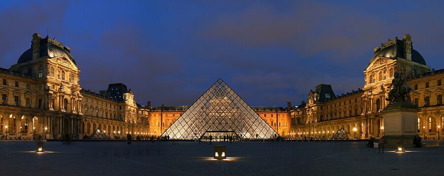 Cour Napoleon at the Louvre at night with pyramid illuminated