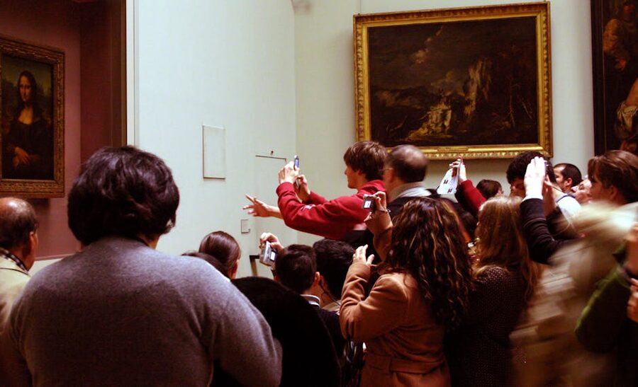 Mona Lisa tourists with phones at the Louvre Paris