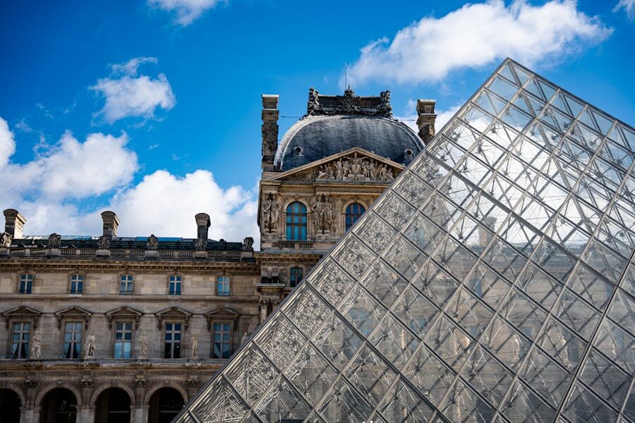 Louvre Pyramid with the historic palace architecture in Paris