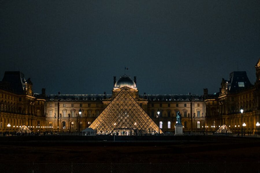 Louvre Pyramid glowing under the Paris night sky