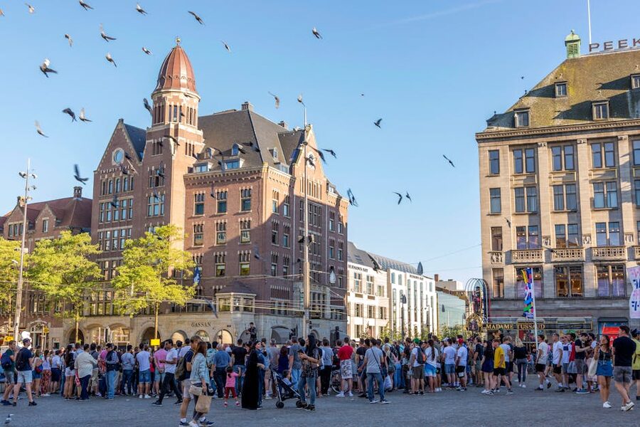 Dam Square Amsterdam during the day with crowd