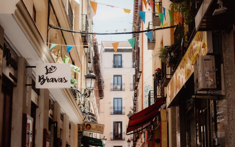 Madrid street with traditional storefronts in Barrio de las Letras quarter near the Prado