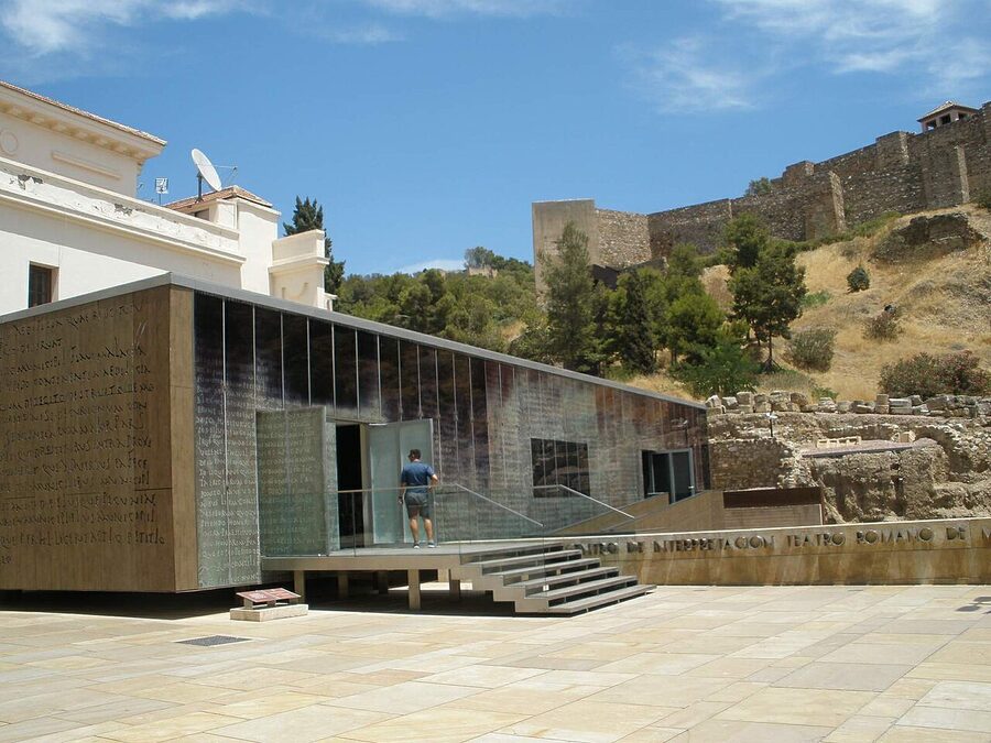 Malaga Roman theatre with Alcazaba fortress walls rising directly behind it