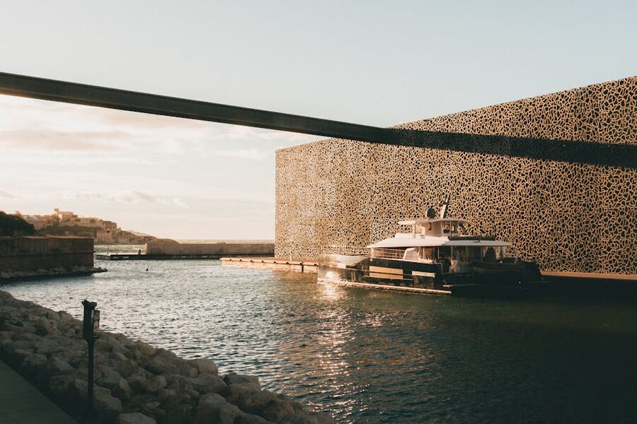 Yacht beside MUCEM in Marseille harbour at sunset