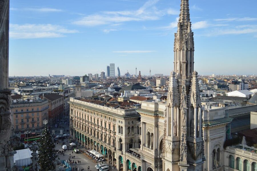 Aerial view of Milan with Duomo spire in foreground