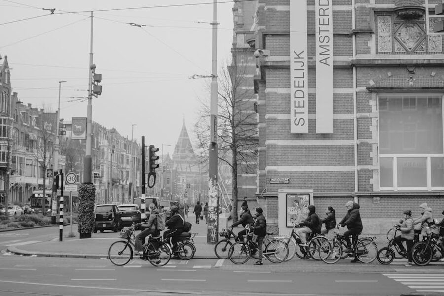 Cyclists waiting at a traffic light on an Amsterdam street