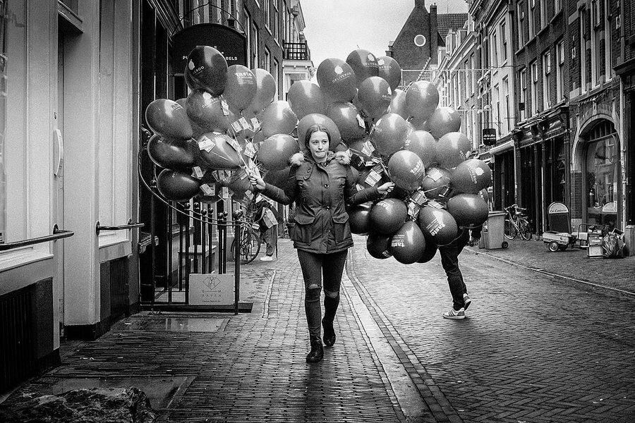 Girl with red balloon imagery referencing Banksy