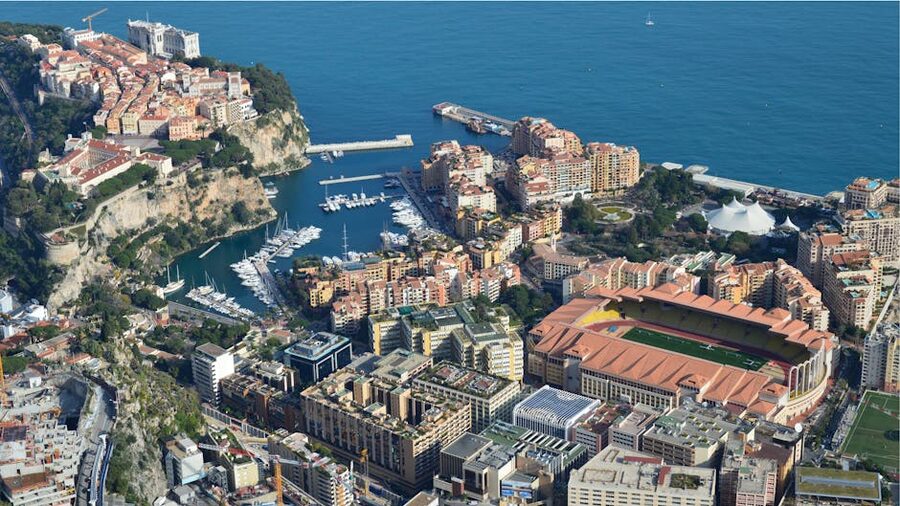 Aerial view of Monaco coastline with marina and high-rise buildings