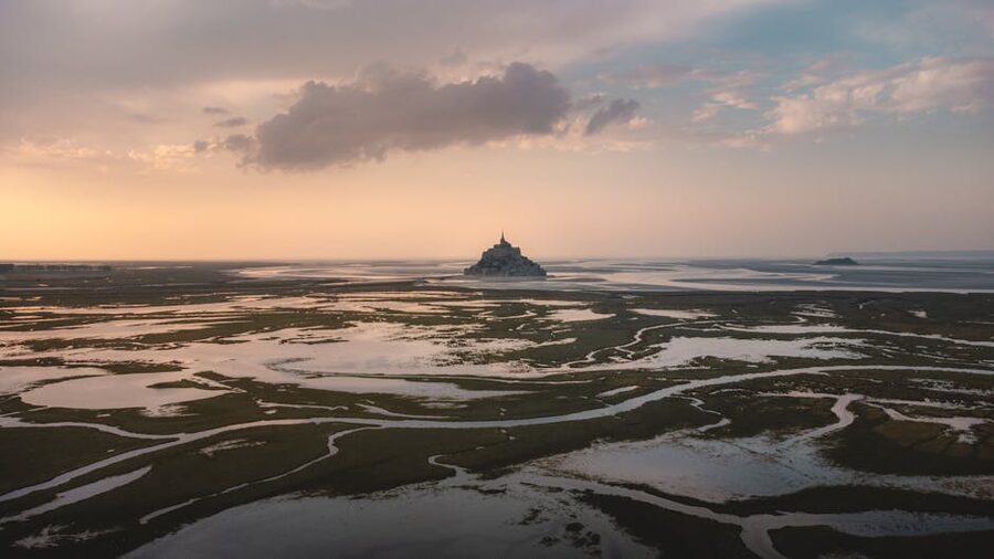 Aerial view of Mont-Saint-Michel at low tide sunset