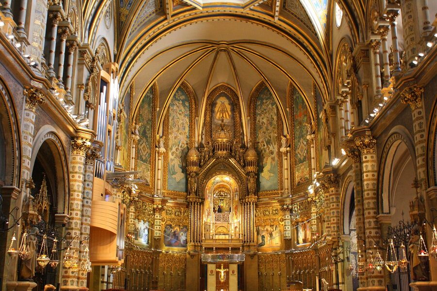 Ornate vaulted ceiling and altar inside the Montserrat basilica