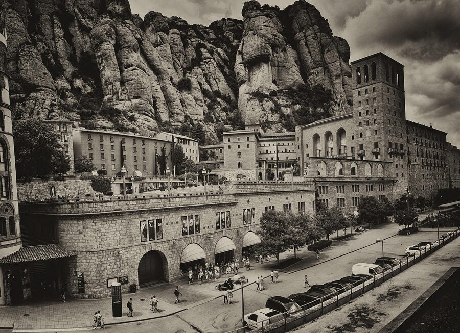Distant view of Montserrat monastery with serrated peaks behind