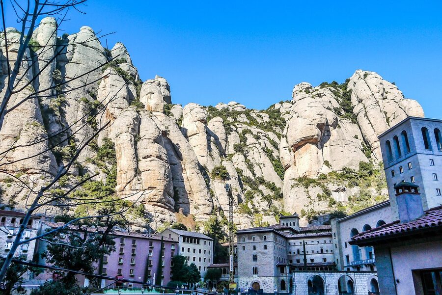 Stone monastery walls of Montserrat at the foot of the rock