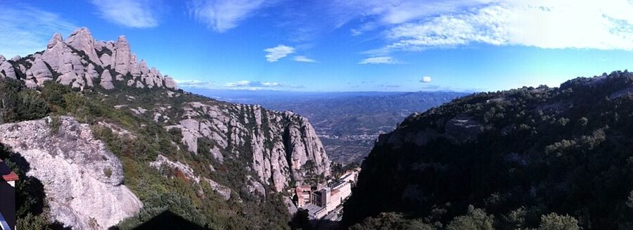 Wide panorama showing the monastery against the Montserrat cliff face