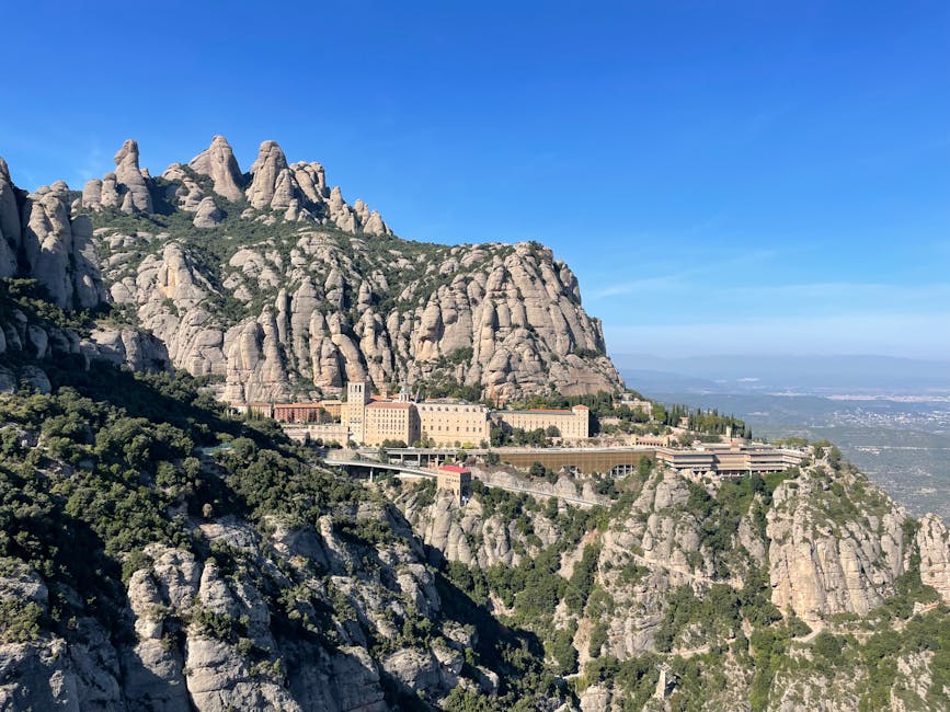 Rugged peaks rise behind the Montserrat monastery rooftops