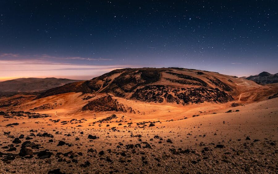 Mount Teide at night with stars rising behind the cone