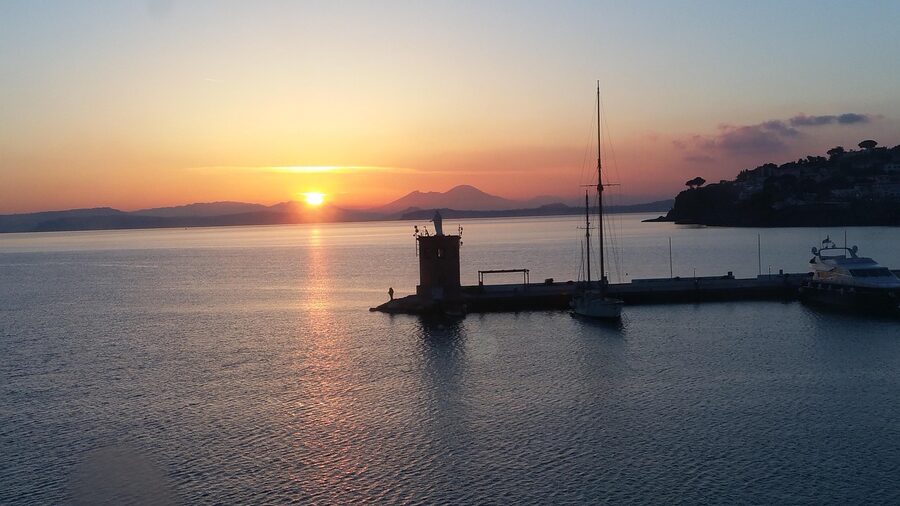 Mount Vesuvius silhouette at sunrise from the Bay of Naples