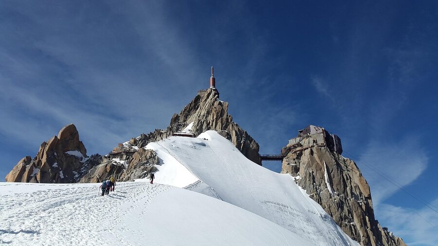 Mountaineers ascending Mont Blanc slopes in snow