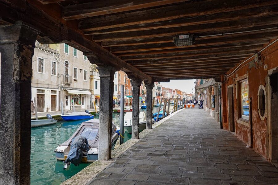Murano canal with rustic buildings and moored boats