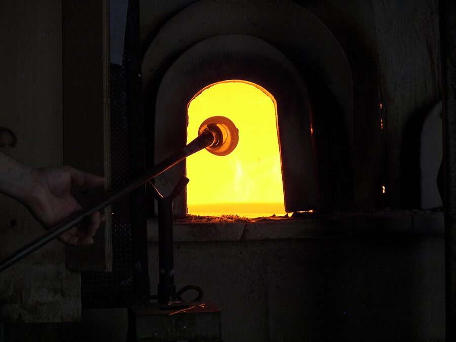 Murano glassblowing pipe being heated inside the furnace