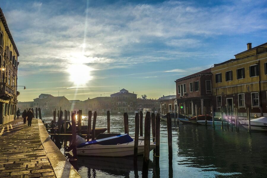 Murano island sunset along the waterway with golden light on the buildings