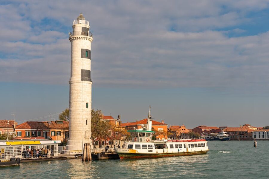 Ferry passing the Murano lighthouse in the afternoon