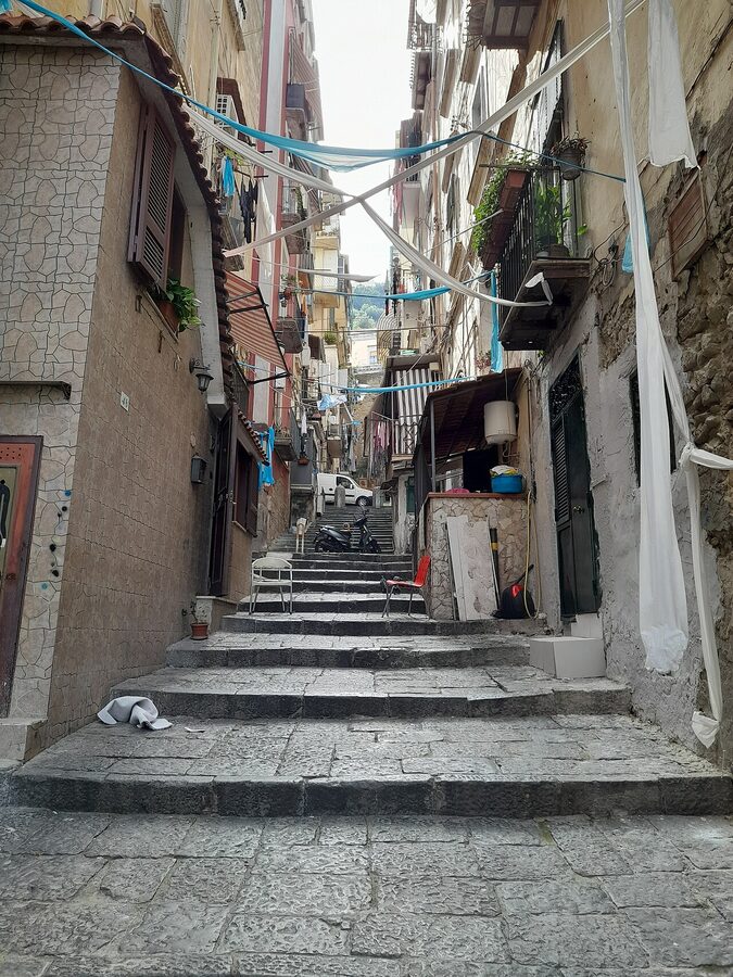 Flags strung overhead between buildings in Quartieri Spagnoli