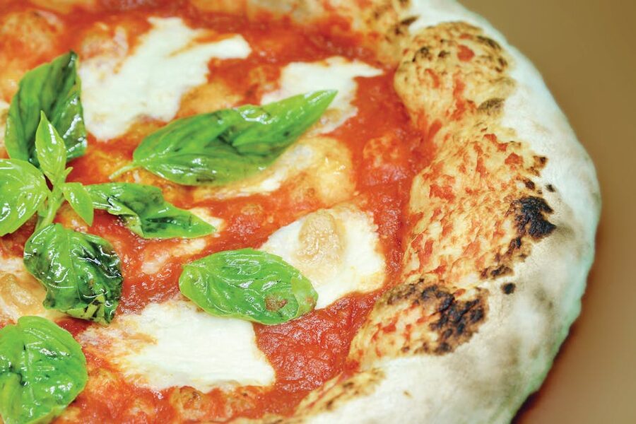 Authentic Neapolitan pizza margherita with fresh basil
