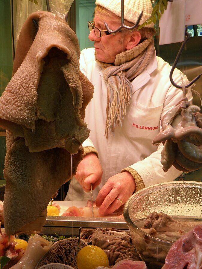 Tripe seller cutting tripe at Pignasecca market Naples