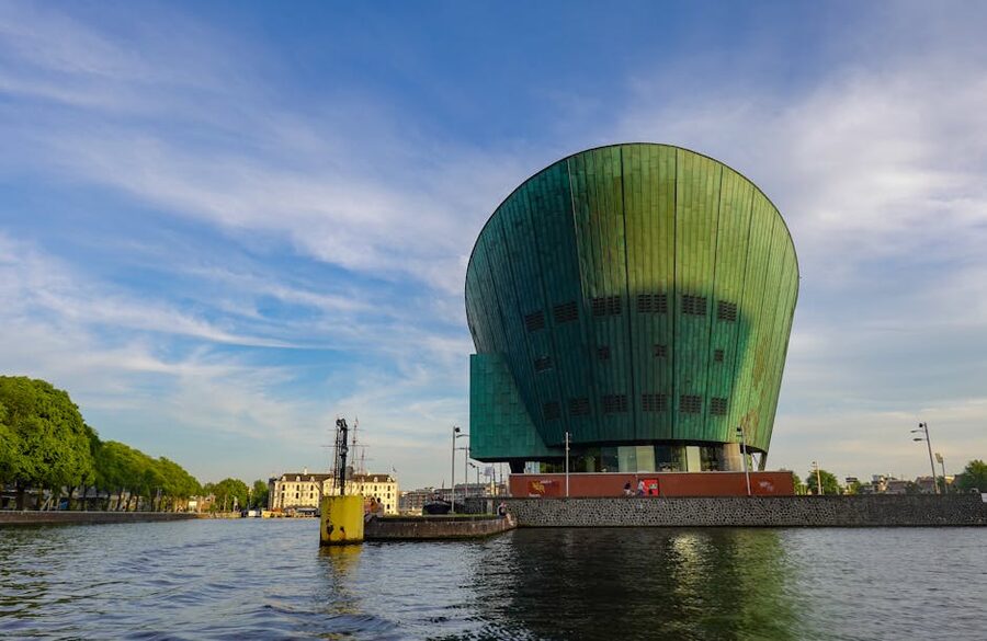NEMO Science Museum green copper hull rising from the IJ harbour Amsterdam
