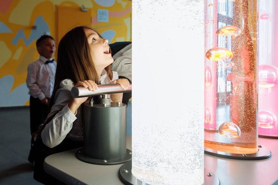 Children engaging with an interactive exhibit featuring colourful liquids
