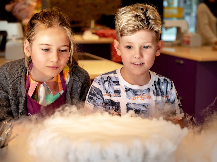 Two children watching a smoky chemistry experiment at a science museum