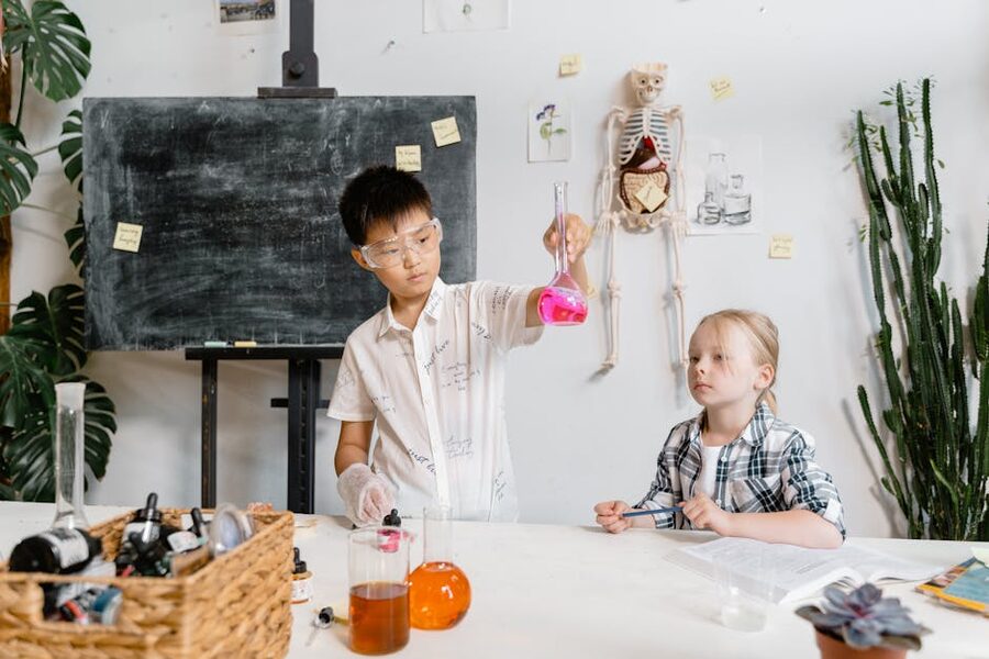 Kids using lab equipment in a science class learning chemistry