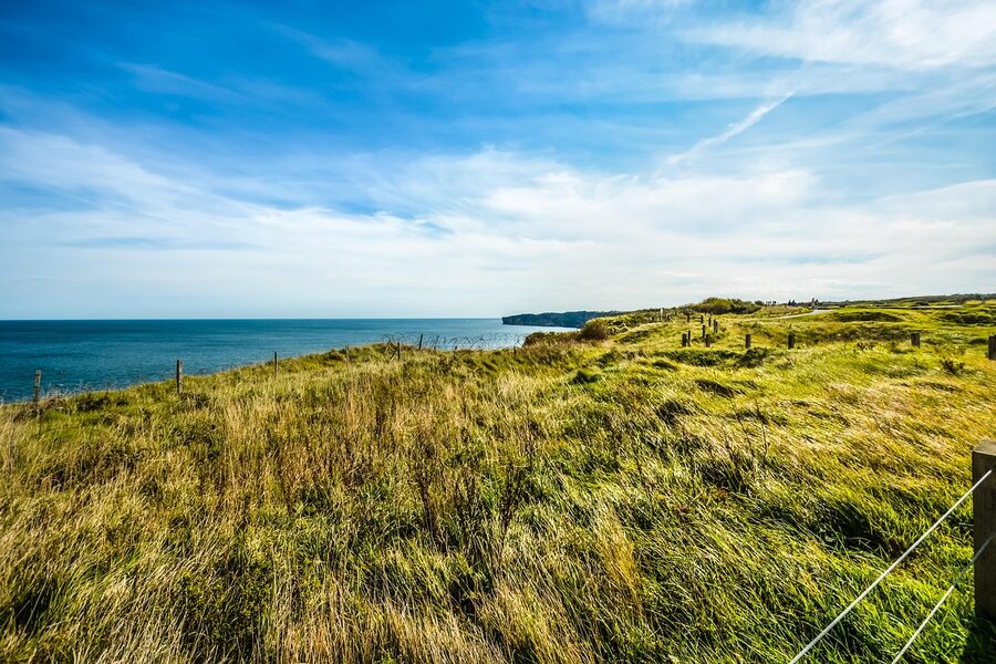 The grassy cratered terrain on top of Pointe du Hoc Normandy