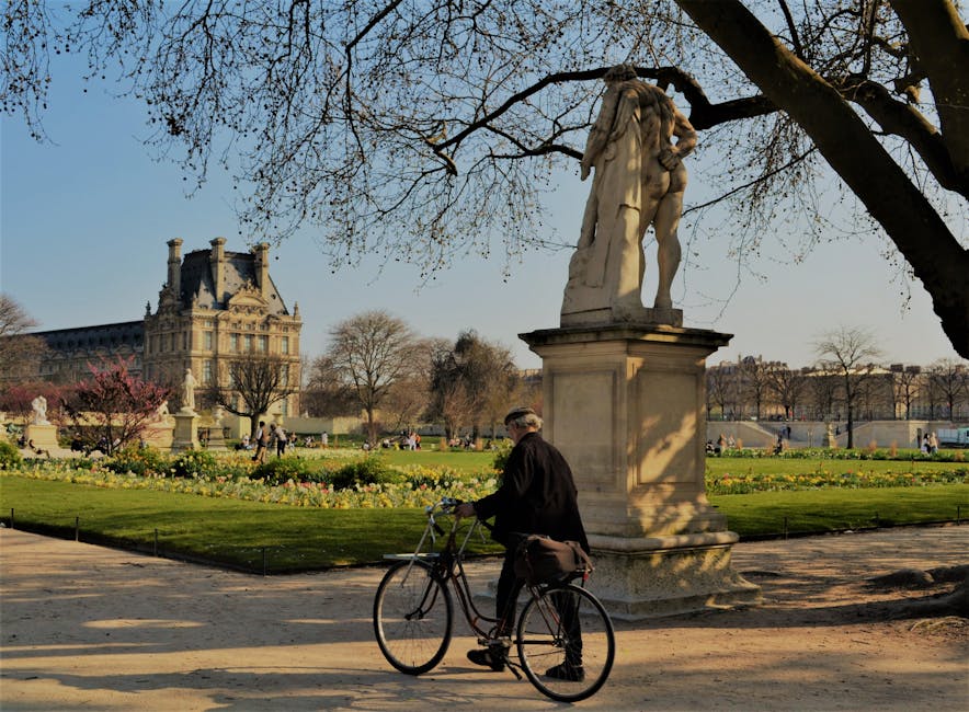 Cyclist in Tuileries Garden looking toward the Louvre