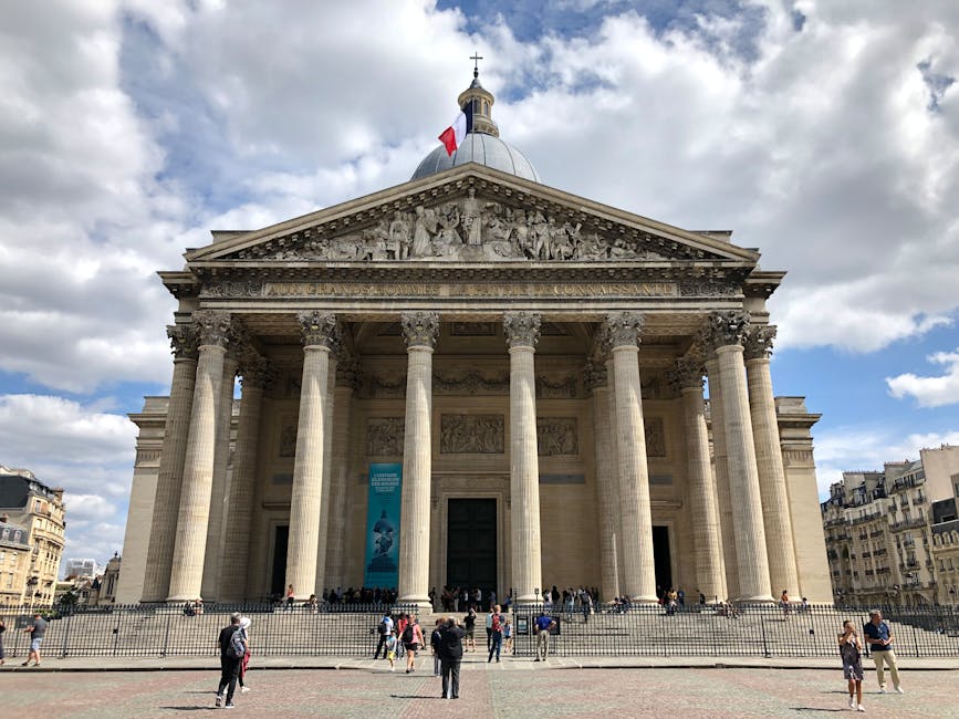 People walking in front of the Panthéon Paris under cloudy sky