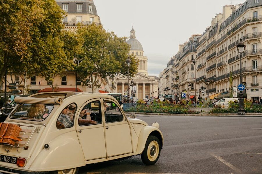 Vintage car parked on a street with the Panthéon in the background