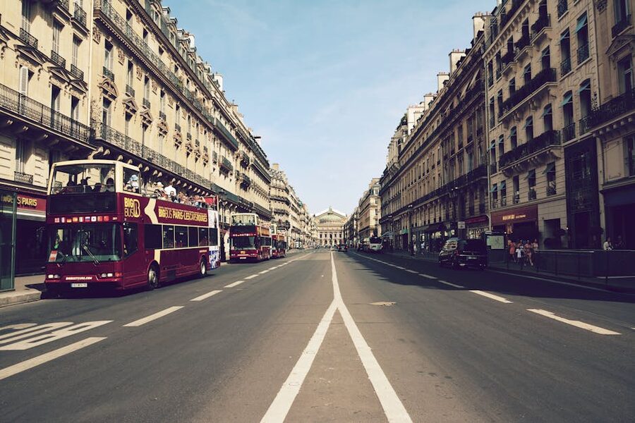 Sightseeing buses on Boulevard Haussmann with Palais Garnier behind them