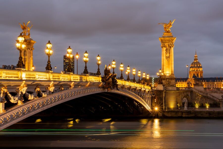 Pont Alexandre III bridge illuminated at dusk in Paris