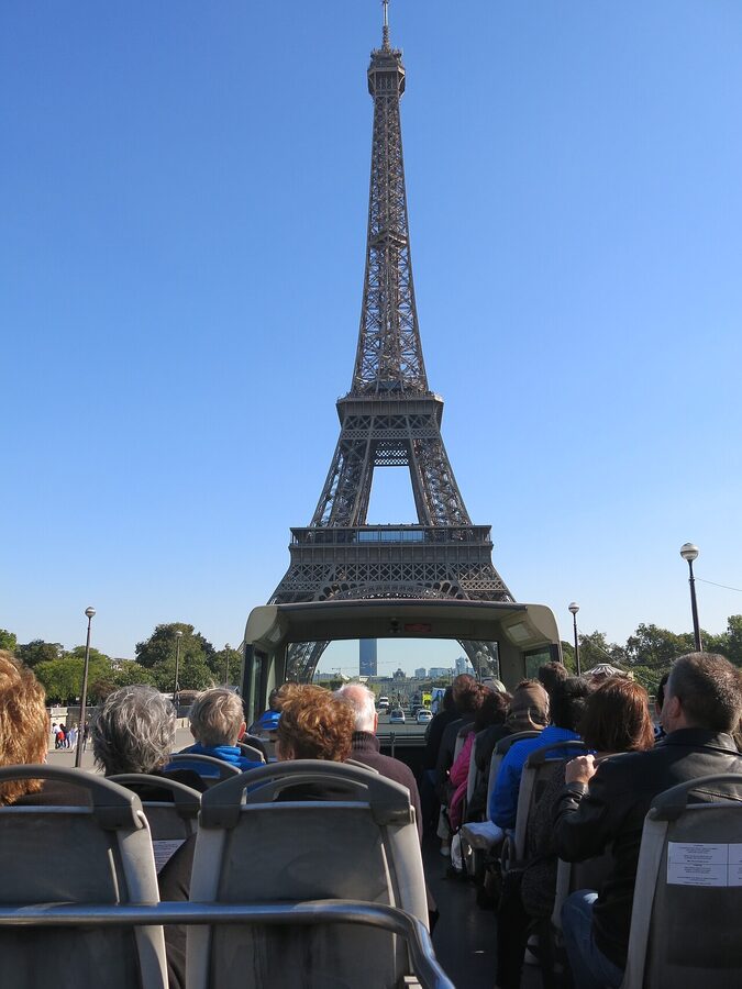 Visitors on a tour bus near the Eiffel Tower