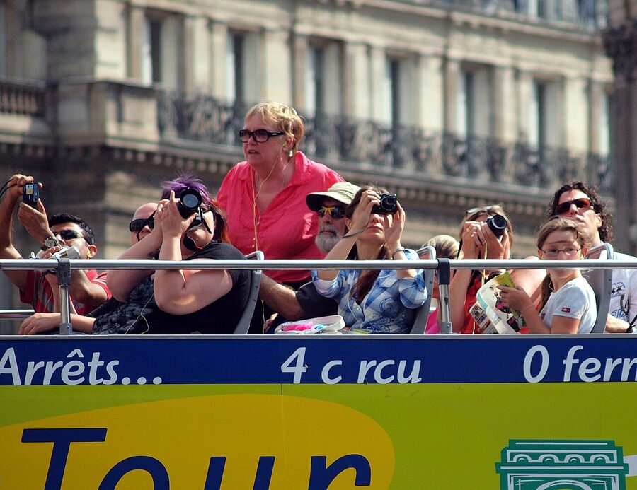 Tourists on an open-top bus in Paris