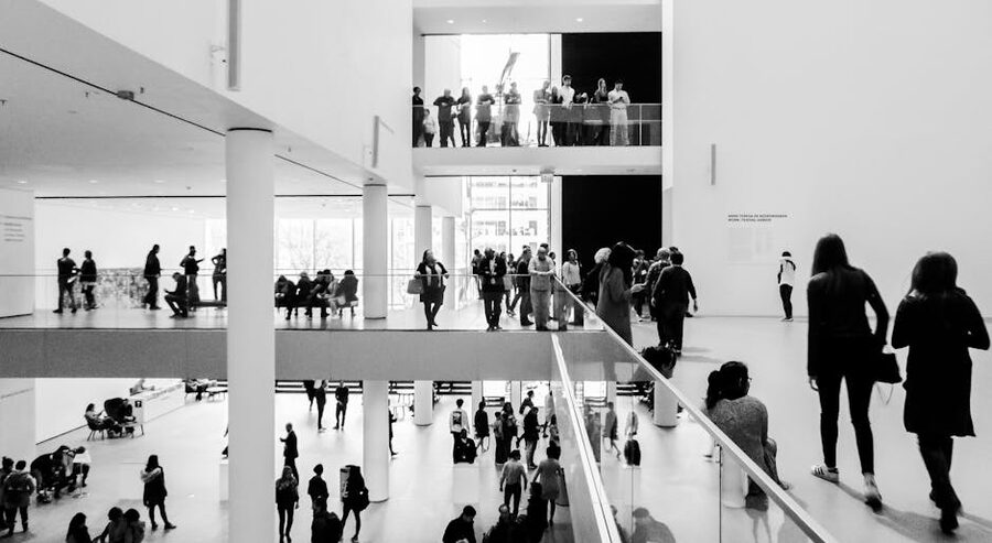 Modern museum interior with visitors black and white