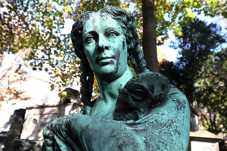 Bronze torso funerary sculpture at Pere Lachaise Cemetery Paris
