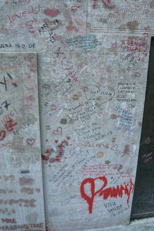 Lipstick kisses and notes on Oscar Wilde grave Pere Lachaise