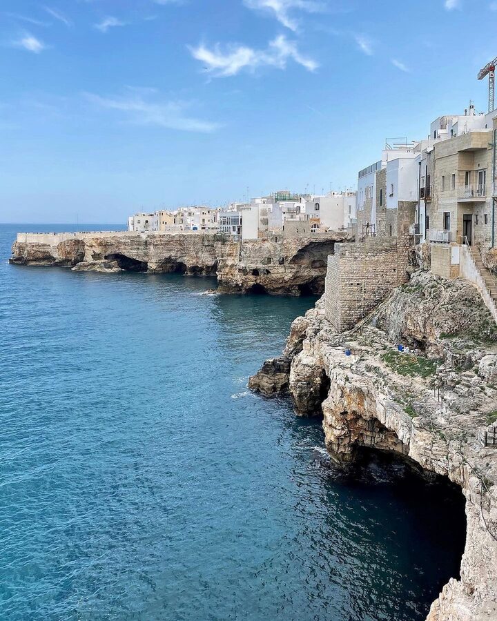 Polignano a Mare seen from the water with cliff houses above