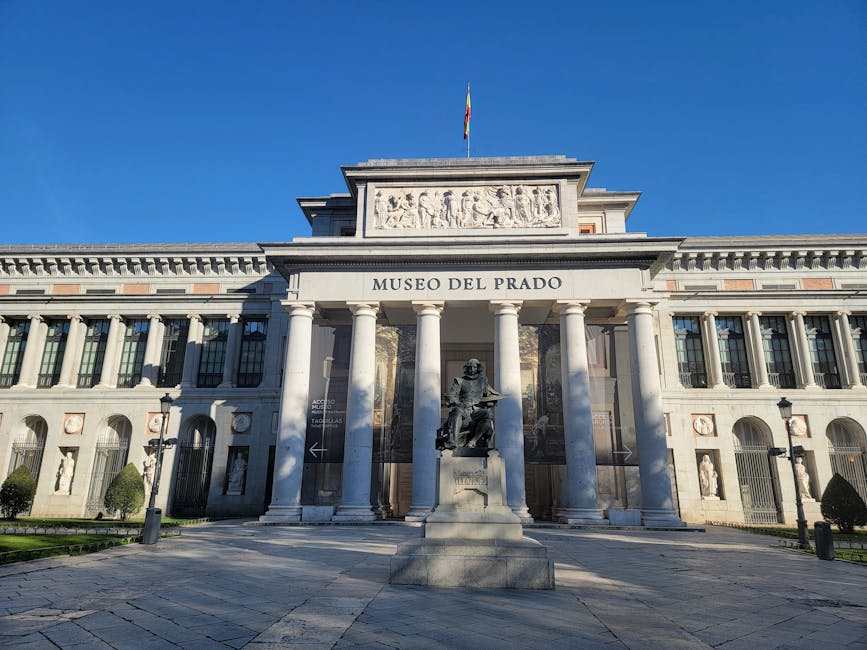 Prado Museum iconic facade under clear blue skies in Madrid Spain