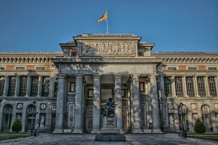 Velazquez statue at the Prado Museum entrance with neoclassical building behind