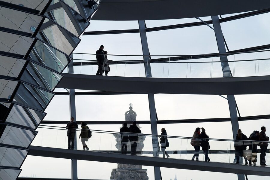 Silhouettes of visitors walking the spiral ramp inside the Reichstag dome