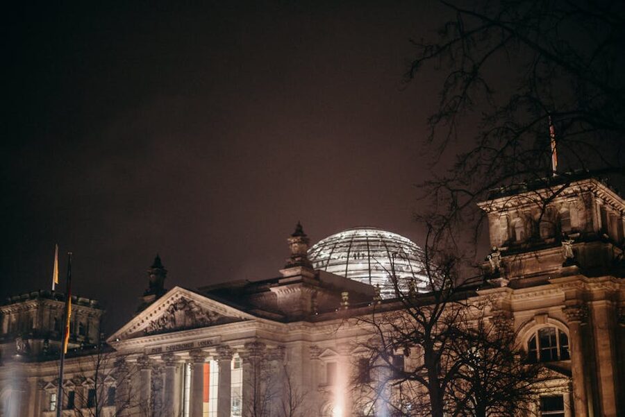 The Reichstag at night with the dome lit and reflecting on the building